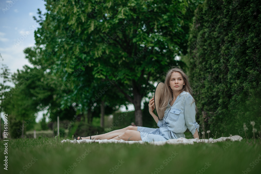 Romantic girl with hat on picnic in park