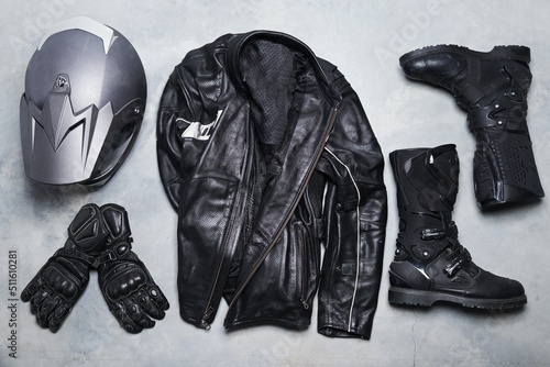 The lifestyle of a rider. High angle shot of biker gear against a gray background.
