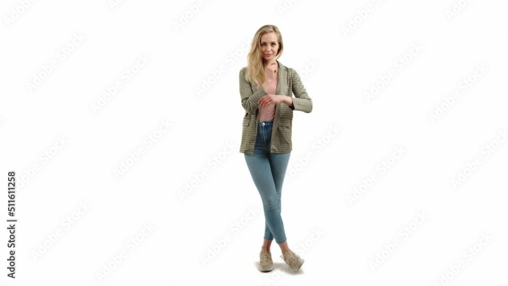 Full length studio shot of an attractive caucasian blond woman in casual clothing standing with her legs crossed and looking at camera. White background. High quality 4k footage Full length studio shot of an attractive caucasian blond woman in casual clothing standing with her legs crossed and looking at camera. White background. High quality 4k footage