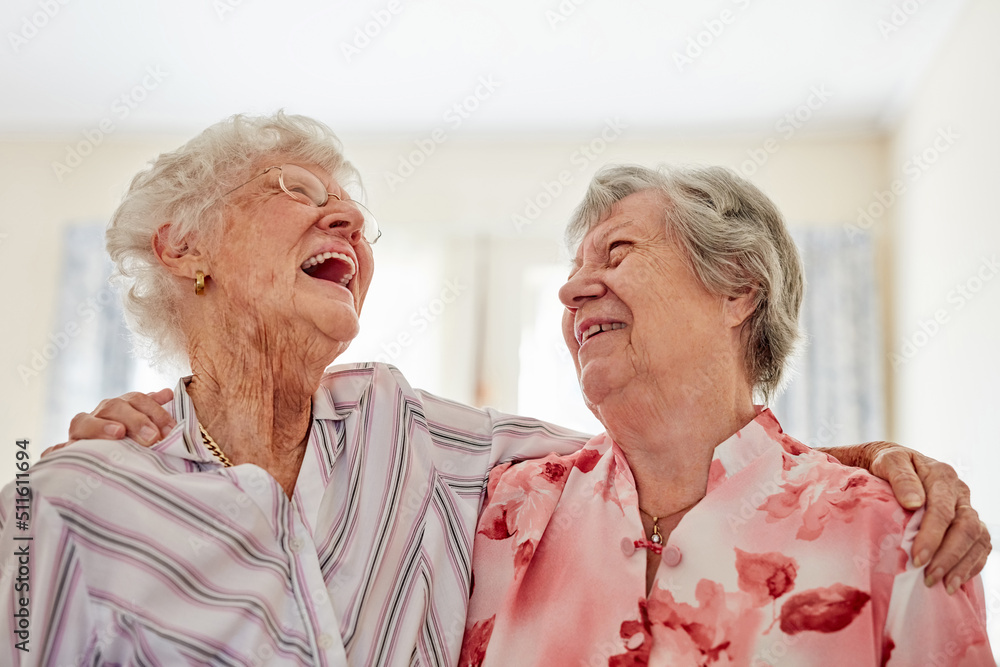 One of lifes greatest pleasures, a good old friend. Shot of two happy elderly women embracing each other at home. - obrazy, fototapety, plakaty 