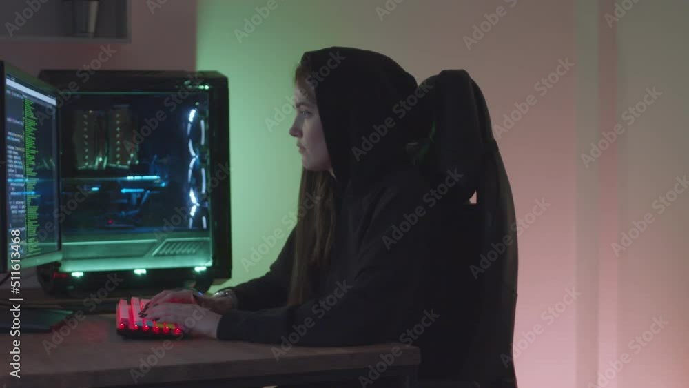 Girl hacker typing at the computer Girl hacker typing at the computer