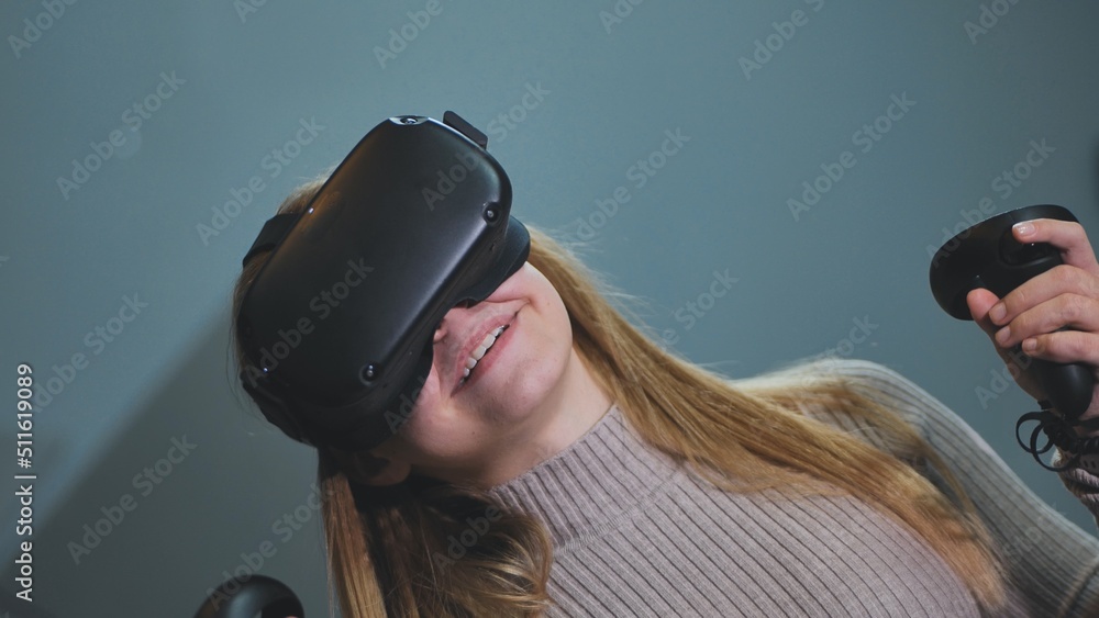 The girl plays virtual reality games in the club. The girl plays virtual reality games in the club.
