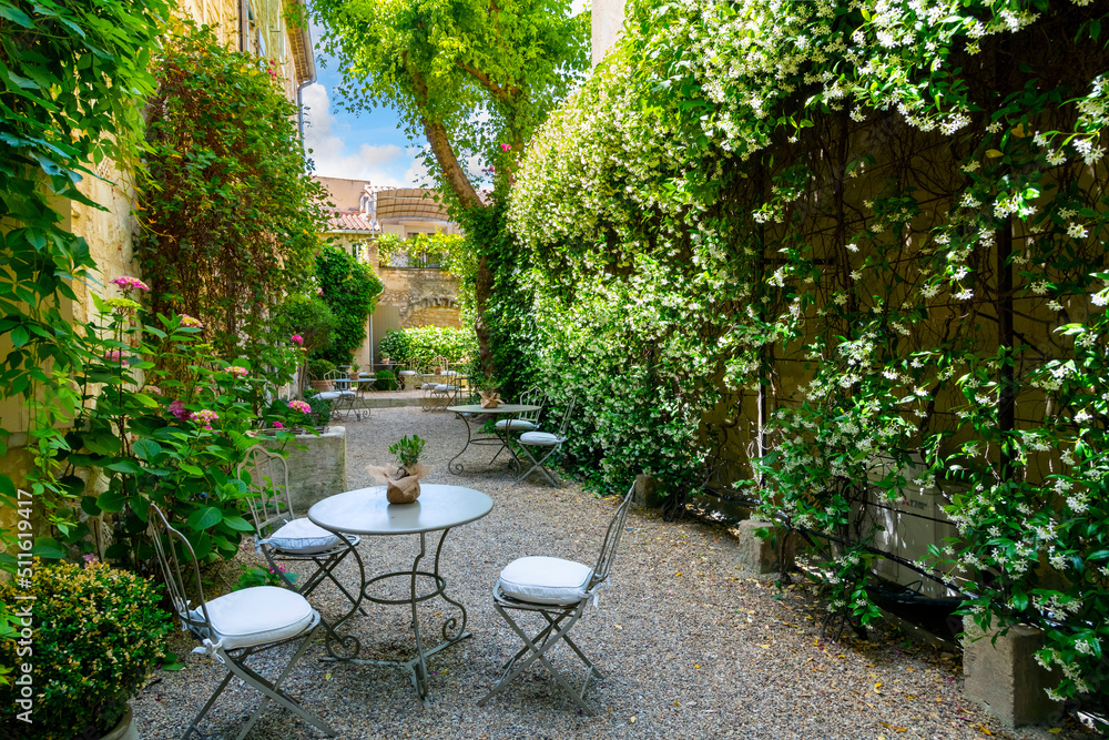 An empty, secluded cafe patio garden in the medieval village of Saint-Remy-de-Provence, in the Provence Cote d'Azur region of Southern France.