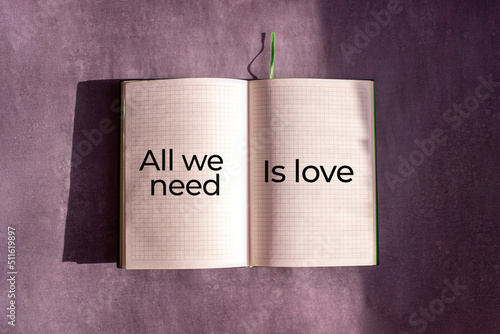 An open notebook is on the gray background. The word 