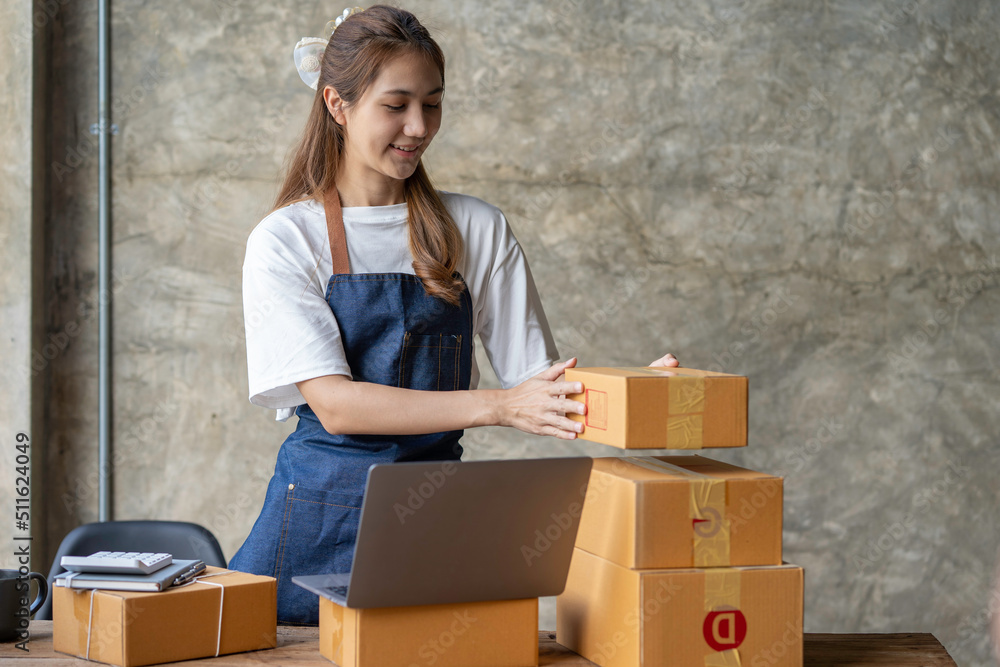 Portrait of Starting small businesses SME owners female entrepreneurs working on receipt box and check online orders to prepare to pack the boxes, sell to customers, sme business ideas online. Portrait of Starting small businesses SME owners female entrepreneurs working on receipt box and check online orders to prepare to pack the boxes, sell to customers, sme business ideas online.
