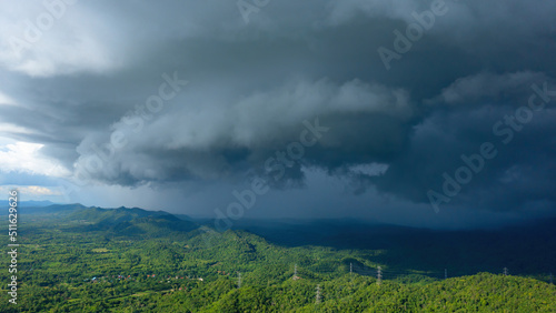 Aerial view rain storms and black clouds moving over the mountains In the north of Thailand, Pang Puai, Mae Moh, Lampang, Thailand. © 24Novembers