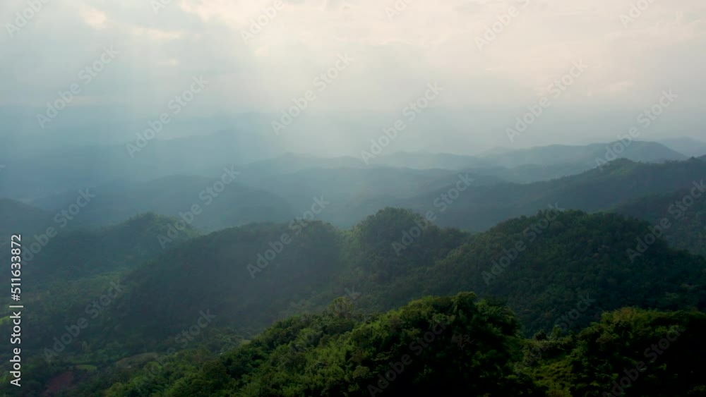 Drone shot flying over beautiful mountain ridge and clouds in rural jungle bush forest .Tree tops against sunny sky. Drone shot flying over beautiful mountain ridge and clouds in rural jungle bush forest .Tree tops against sunny sky.