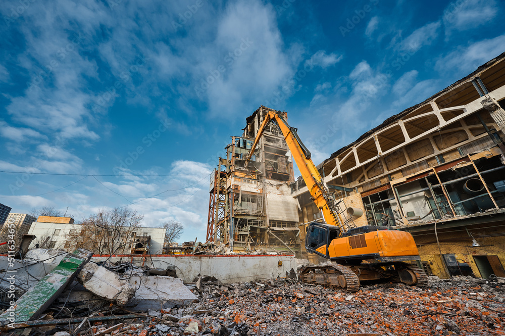 Hydraulic excavators at demolition site of industrial complex Hydraulic excavators at demolition site of industrial complex