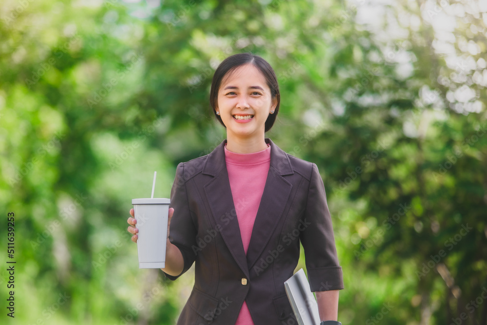 business woman Standing drink coffee in the park beside the town business woman Standing drink coffee in the park beside the town
