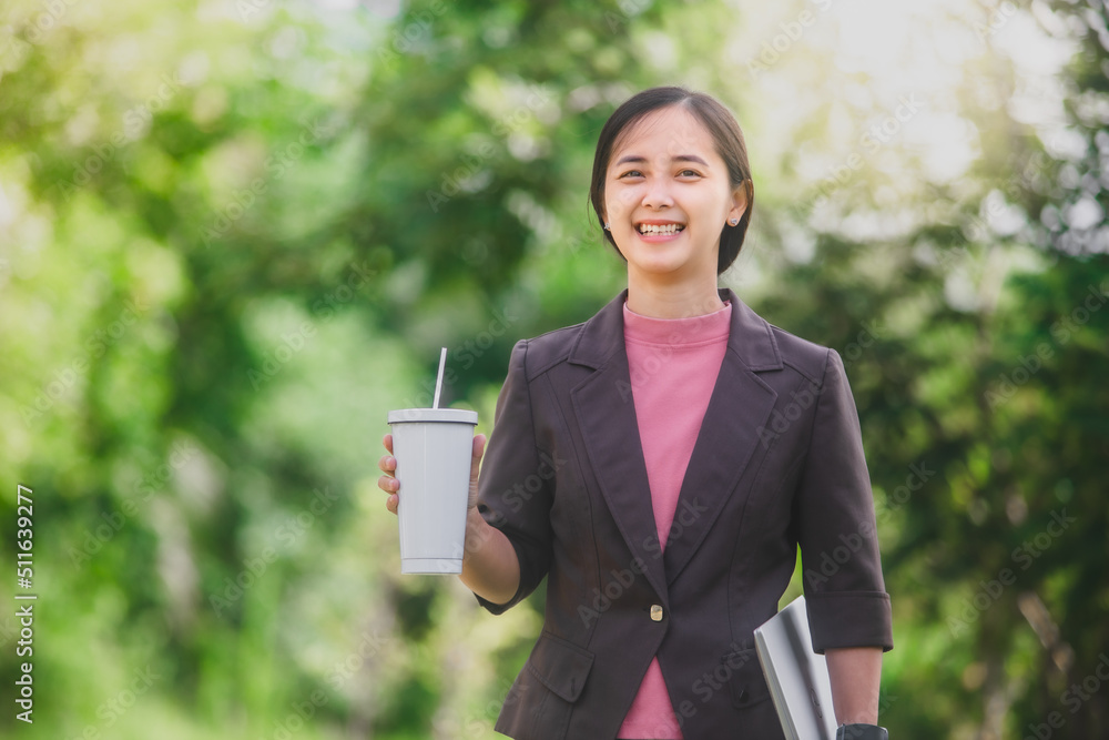 business woman Standing drink coffee in the park beside the town business woman Standing drink coffee in the park beside the town