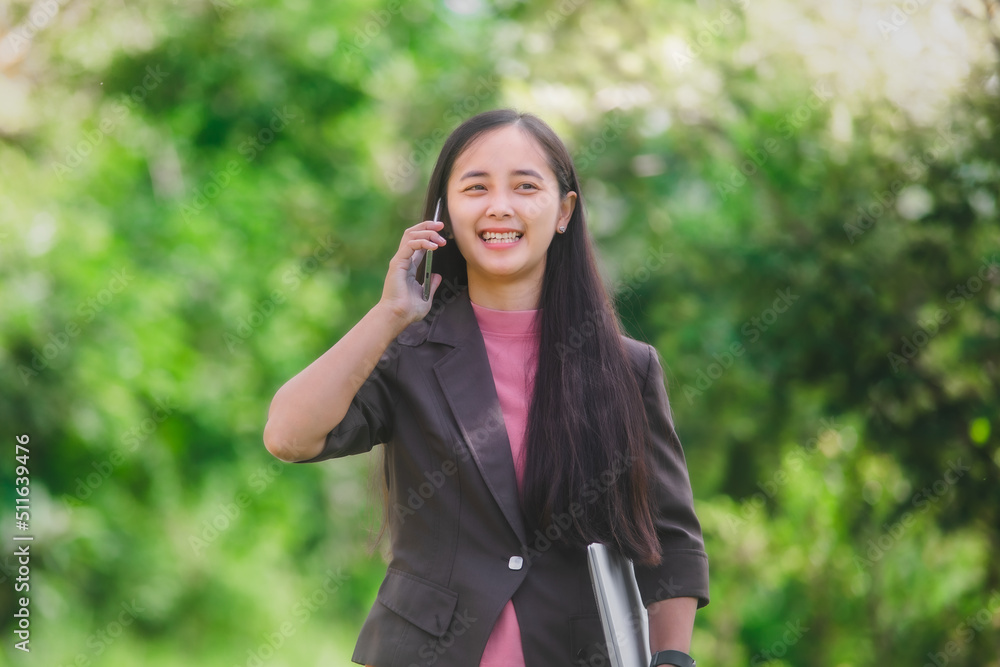 business woman Standing on the phone in the park beside the town business woman Standing on the phone in the park beside the town