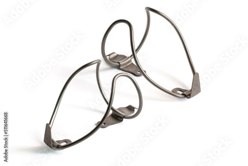 Stainless steel water bottle cages for bicycles on white background.