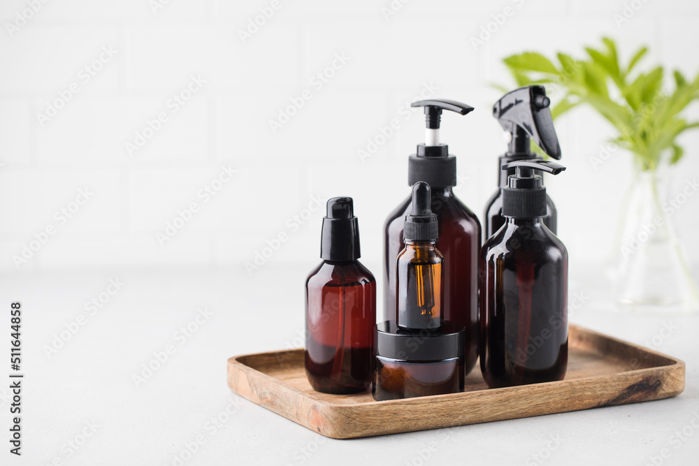 Different brown glass bottles with eco friendly organic beauty products. Concept natural DIY cosmetics. Different brown glass bottles with eco friendly organic beauty products. Concept natural DIY cosmetics.