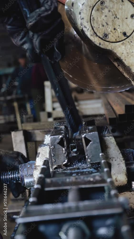 A factory worker cuts metal. Sparks fly. Production A factory worker cuts metal. Sparks fly. Production