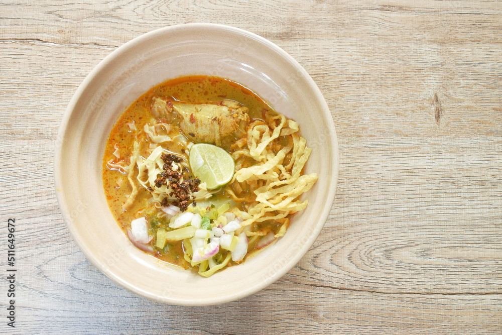 Thai northern style curry noodles in coconut milk soup with chicken on bowl Thai northern style curry noodles in coconut milk soup with chicken on bowl