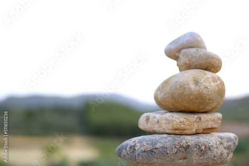 Set of different stones stacked in a rural landscape.