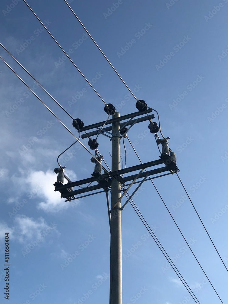 Electricity pole and power line under white cloud and blue sky Electricity pole and power line under white cloud and blue sky