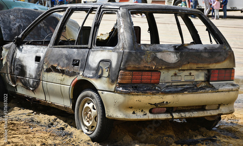 Burned broken car after a car accident photo