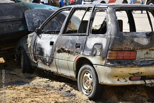 Burned broken car after a car accident photo