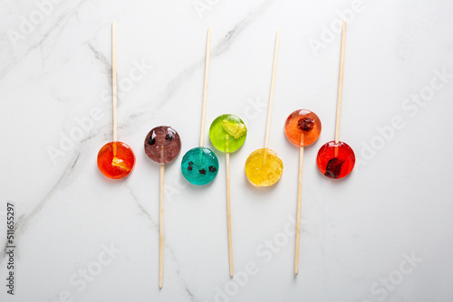 Top view of  mealting homemade fruits candy lollipop photo