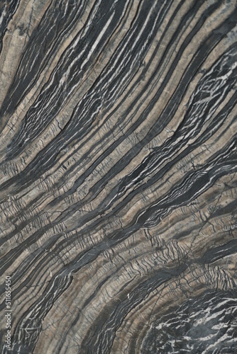 Close up of stone slab shows beautiful natural mineral pattern that perhaps flowed in Paleolithic period, resulted in stunning graphic in various forms under the crust. Unique in characters are formed