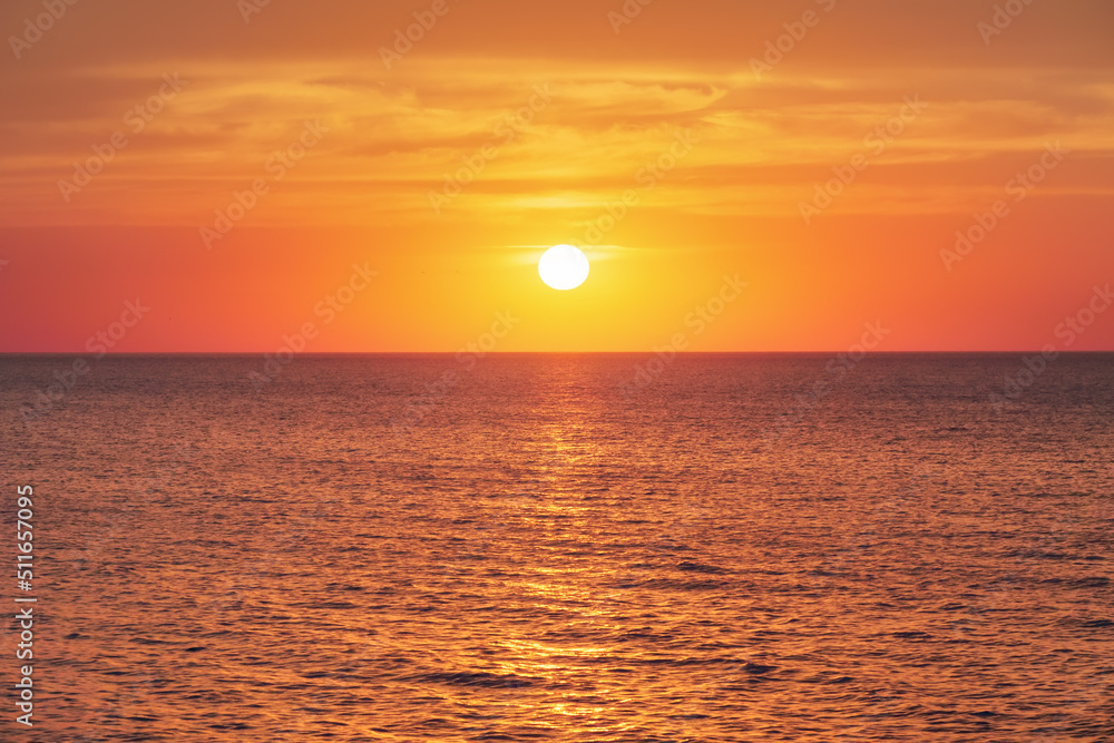 Bright sunset under the sea surface