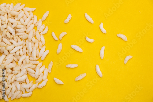 Puffed rice isolated on yellow background.