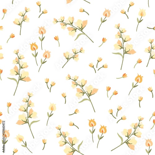 Delicately yellow and orange embroidered bluebells, tulips and small buds isolated on white background in vector. Seamless floral print for fabric, wallpaper.
