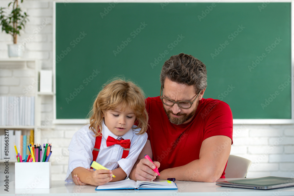 Kid boy learning with teacher. Funny little boy study with father in class on blackboard. Child from elementary school. Cute elementary school boy. Kid boy learning with teacher. Funny little boy study with father in class on blackboard. Child from elementary school. Cute elementary school boy.