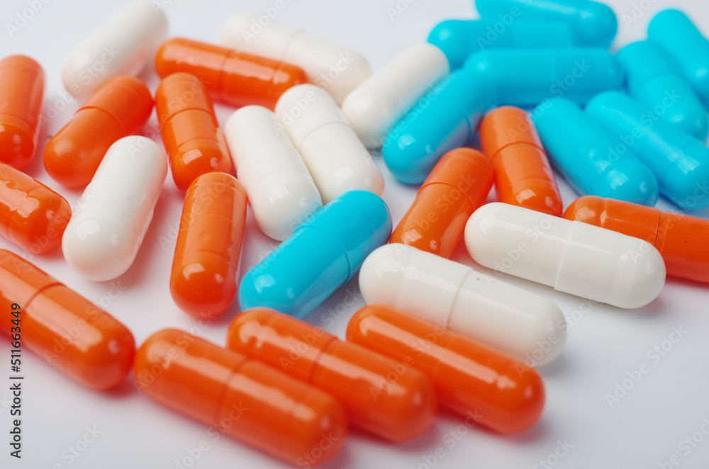 Colored pharmaceutical pills on white. Close-up.