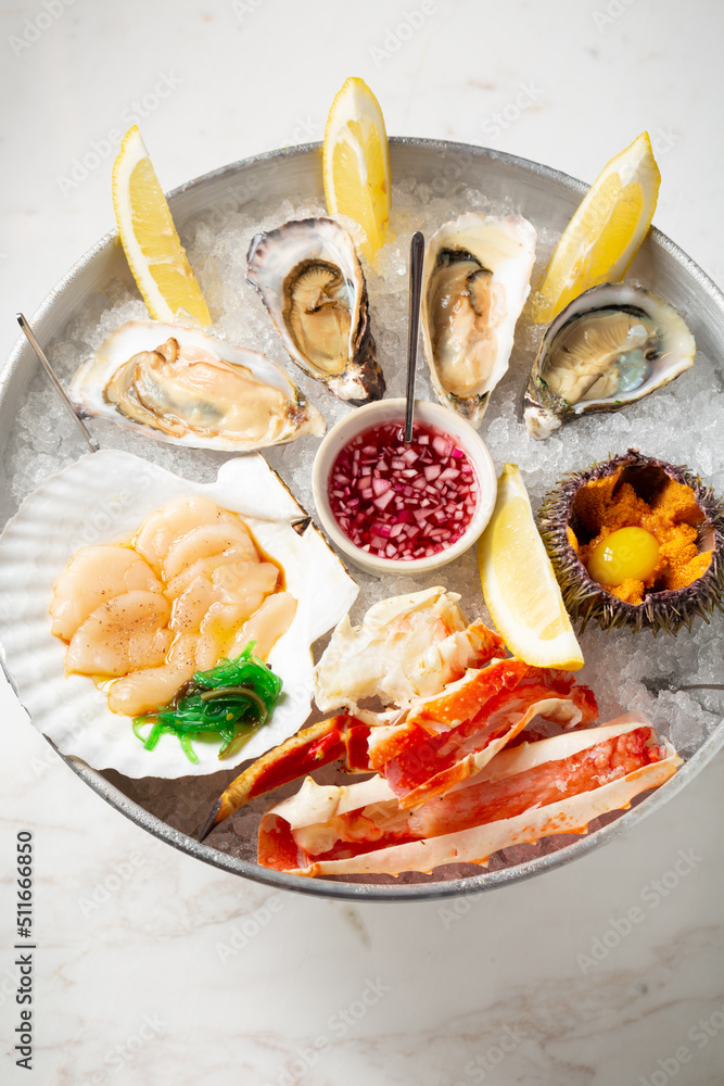 Seafood mix: scallops, oysters, sea urchin, crab phalanges and balsamic sauce, top view