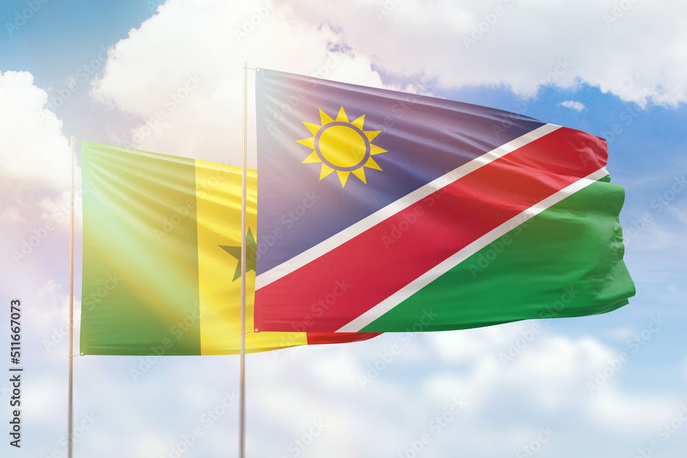 Sunny blue sky and flags of namibia and senegal Sunny blue sky and flags of namibia and senegal