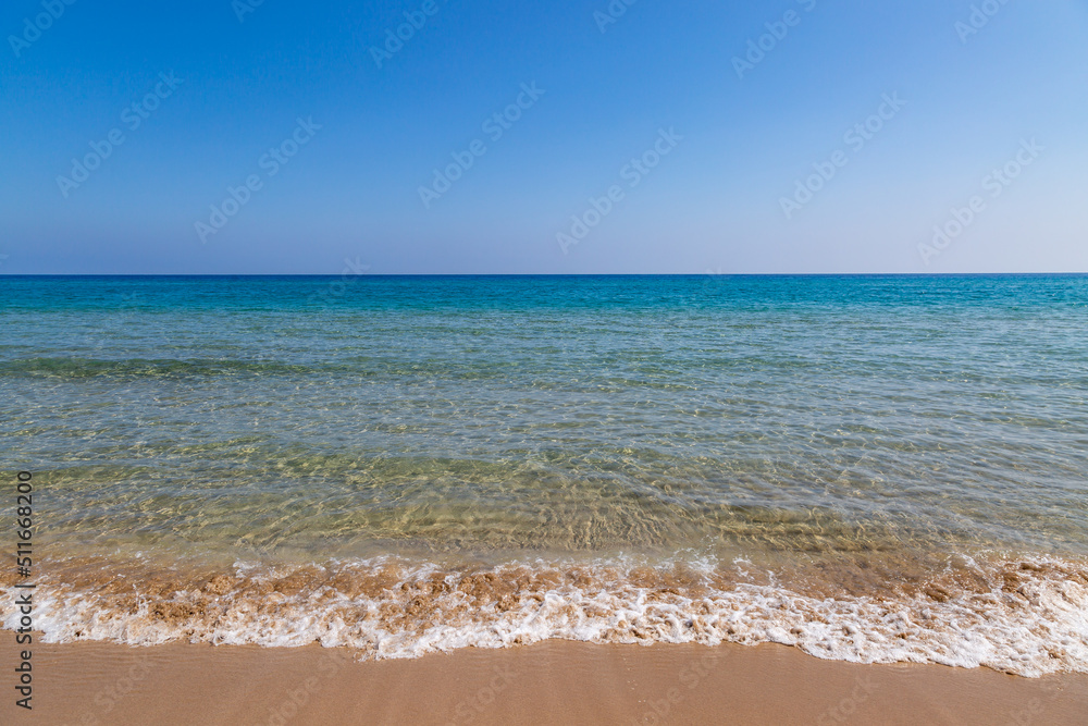 A view out over the sea at Golden Beach in Cyprus, with a clear sky overhead