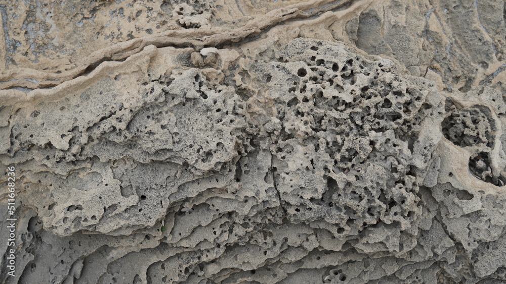 Fototapeta premium Volcanogenic rock slabs on the seashore. Natural rocky breakwater at seashore