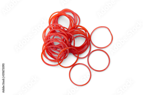 Elastic red rubber bands on white background. Concept : A versatile rubber band for tying things, bags or hair, can be reuse for many times. photo