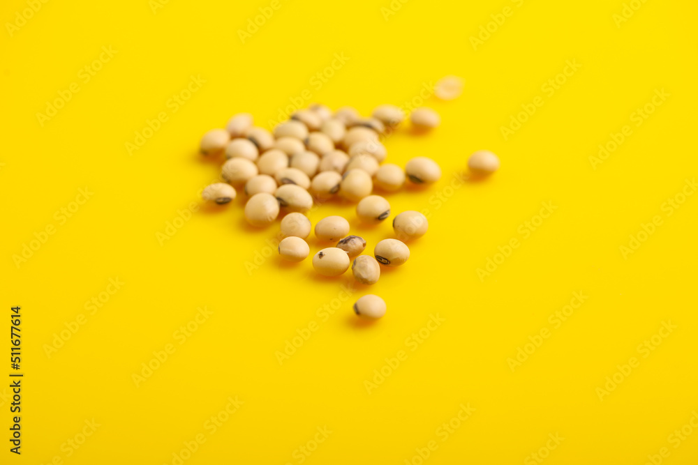 Dry soybean seed on yellow background. Dry soybean seed on yellow background.