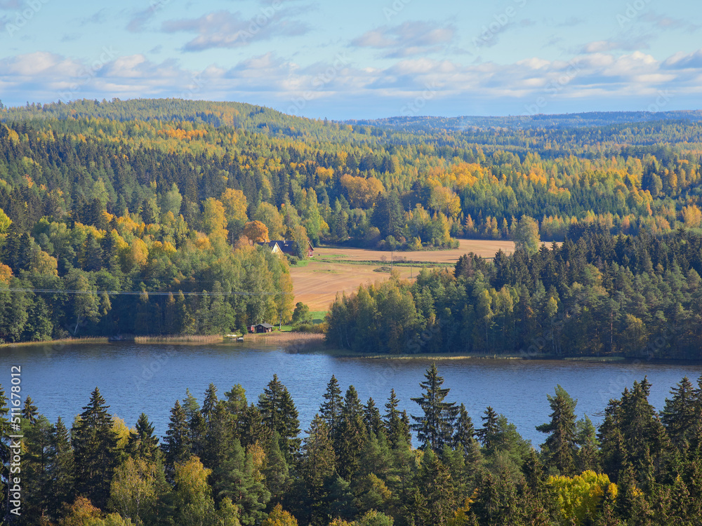 Fototapeta premium Top of Aulanko lookout tower near Hamenlinna town in Finland: colorfuls forests, lake, clouds.