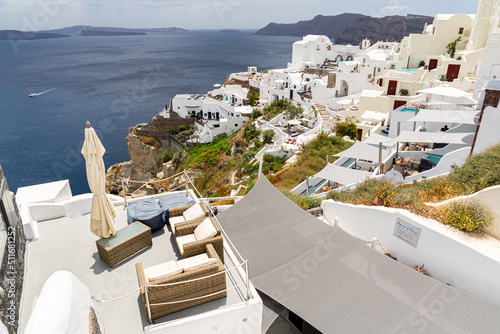 View over iconic Oia on Santorini island with a sunny terrace in the foreground