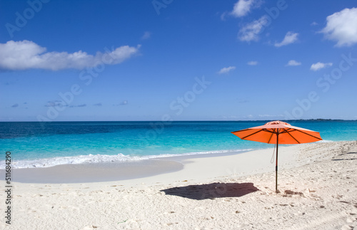  Red umbrella on white sand beach in Nassau  Bahamas