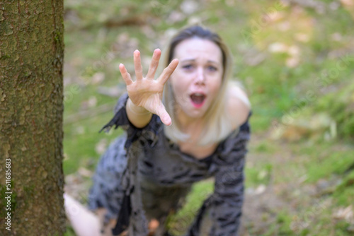 Anguished woman screaming and reaching up to the camera photo