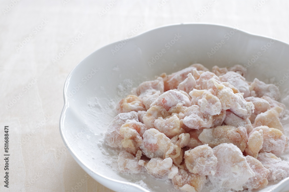 Chinese cooking, corn starch mixed with Chicken soft bone prepared for deep frying Chinese cooking, corn starch mixed with Chicken soft bone prepared for deep frying