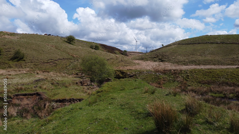 Obraz premium Aerial view of rural mountain terrain with a cloudy sky background. 