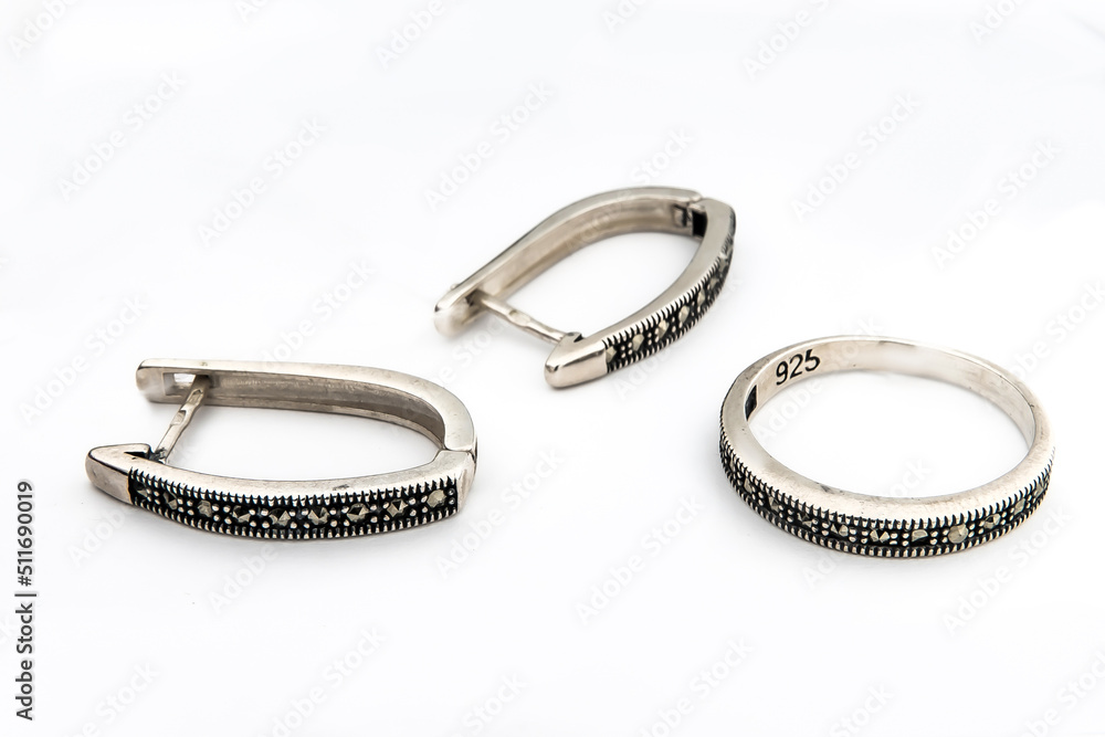 Silver jewelry set of ring and silver earrings with stones on white background. Silver jewelry set collection Silver jewelry set of ring and silver earrings with stones on white background. Silver jewelry set collection