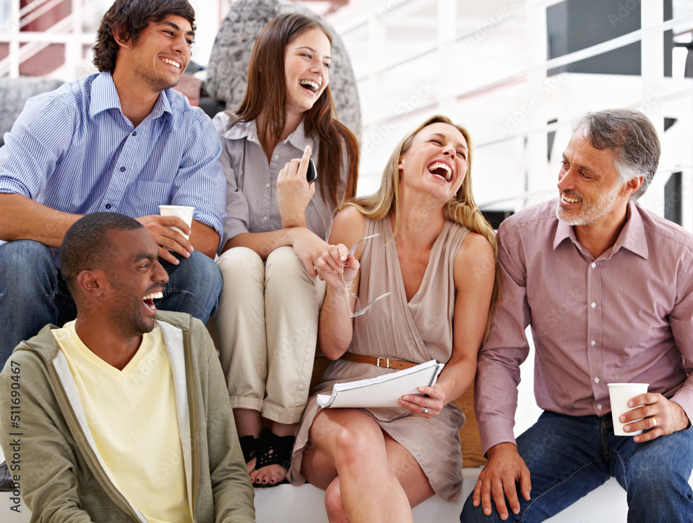 Working with a great team. A team of designers laughing at their colleagues joke. Working with a great team. A team of designers laughing at their colleagues joke.