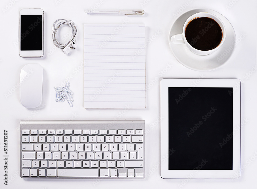 Instruments of productivity. A high angle view of various office equipment items and digital devices. Instruments of productivity. A high angle view of various office equipment items and digital devices.