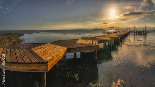 Coastal landscape at sunrise with wooden walkways