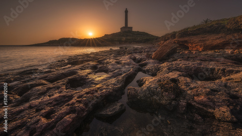 Coastal landscape with the Cabo de Palos lighthouse at sunset