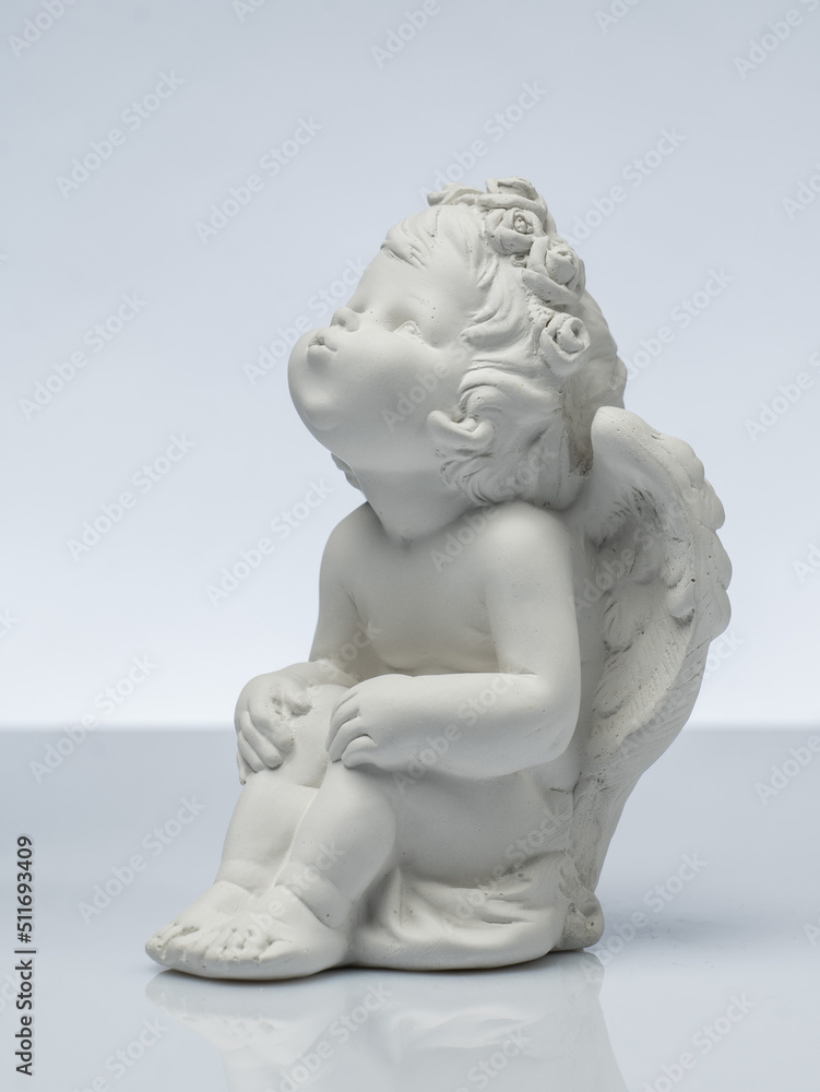 plaster white statuette in the form of an angel on a white background plaster white statuette in the form of an angel on a white background
