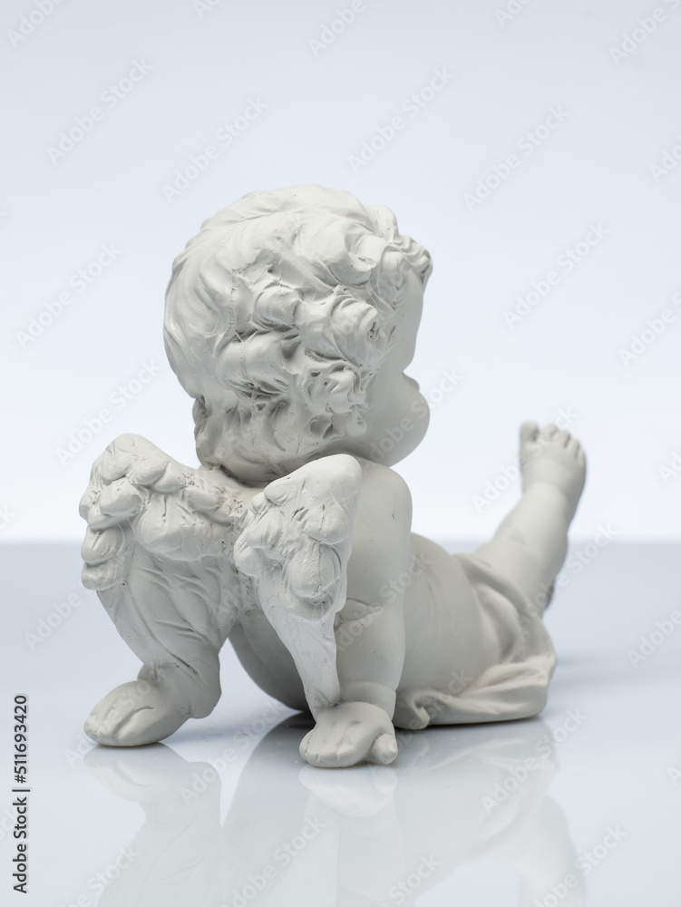 plaster white statuette in the form of an angel on a white background plaster white statuette in the form of an angel on a white background
