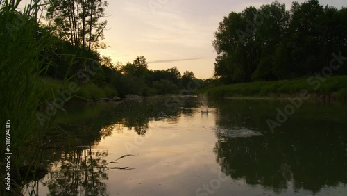Time lapse sunset over a river, Wonderfull colorful clouds, water surrounded by tress